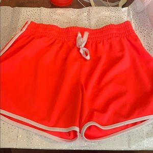 Neon pink and white exercise shorts